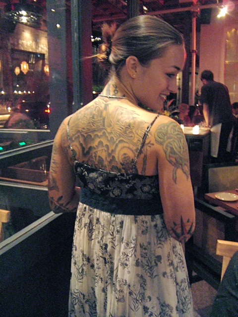 We are mesmerized by lacey tattoos revealed by the hostess’s demure lace dress.  Photo: Steven Richter 